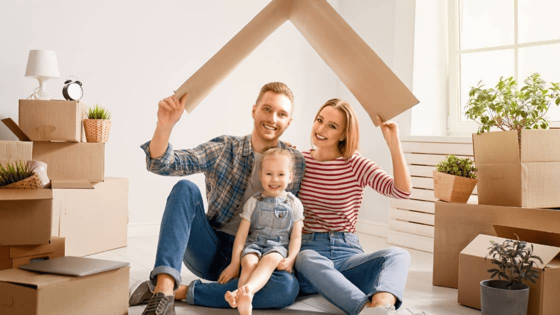 How to Plan a Successful Moving and Renovating Project 1 A family unpacking on their new house, smiling and happy