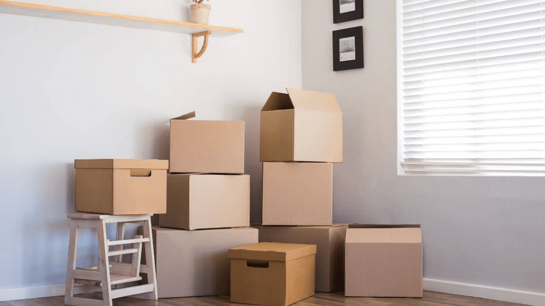 How to Plan a Successful Moving and Renovating Project 6 A photo of a newly renovated room with moving boxes in the corner, showcasing the process of moving and renovating to make the most of your new space.
